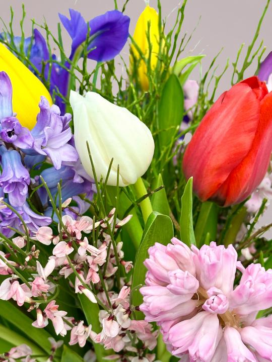 Voorjaarsboeket met tulpen, hyacinten en ranonkels als sfeervol accent in huis