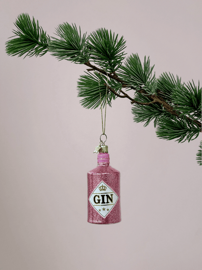 Ornament Vondels Ginfles Roze met glitters hangend in kerstboom met lichtroze achtergrond.