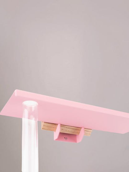 Achterzijde van de lichtroze bloemenplank met bracket voor bloemen aan de muur.