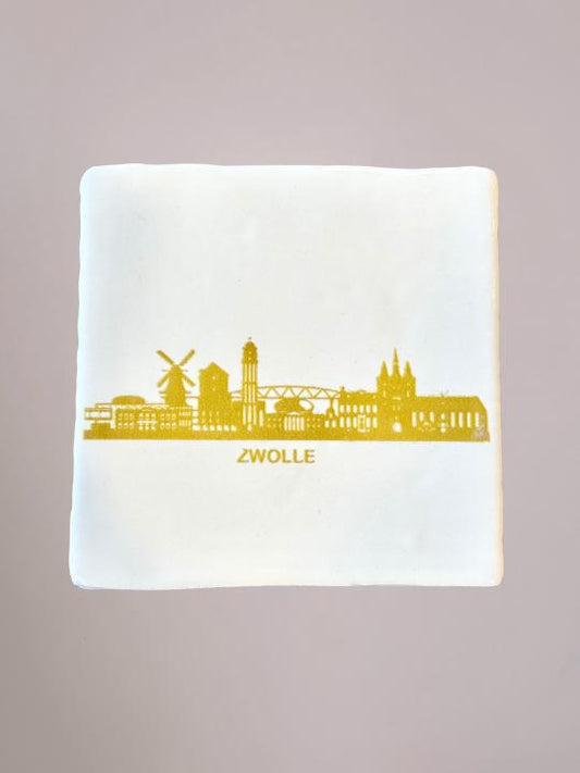 Minimalistisch wit tegeltje met goudkleurige Zwolle-print, exclusief ontworpen door Yett Agenturen voor Anja Bloementrends.